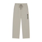 A pair of light beige drawstring sweatpants with the brand name 'REVIVAL' printed vertically in black on the left leg, shown against a plain white background.