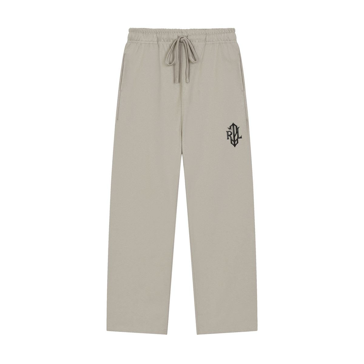 A pair of light beige drawstring sweatpants with a small colorful graphic patch on the left hip, displayed against a solid white background.