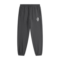 Dark gray tapered jogger pants with a drawstring waist, side pockets, elastic cuffs, and a small white monogram logo on the upper thigh.



