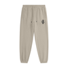 Apricot jogger pants with a brand logo on a white background