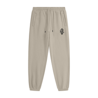 Apricot jogger pants with a brand logo on a white background