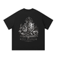 Black T-shirt featuring a monochrome gothic ruins graphic with a central cross-like figure and “Still Standing” Chapter II lettering.



