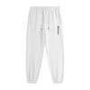 White tapered jogger pants with an elastic drawstring waistband, side pockets, elastic cuffs, and vertical black REVIVAL lettering on the upper thigh.

