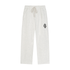 Light heather gray sweatpants with an elastic drawstring waist and a small green circular patch on the left thigh, shown against a plain white background.