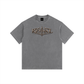 A gray short-sleeve t-shirt with a distressed metallic bronze graphic on the chest reading 'REVIVAL MARCH'. The t-shirt is displayed flat against a solid white background.