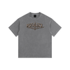 A gray short-sleeve t-shirt with a distressed metallic bronze graphic on the chest reading 'REVIVAL MARCH'. The t-shirt is displayed flat against a solid white background.