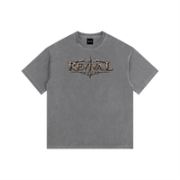 A gray short-sleeve t-shirt with a distressed metallic bronze graphic on the chest reading 'REVIVAL MARCH'. The t-shirt is displayed flat against a solid white background.