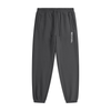 Black jogger pants with a logo on a white background