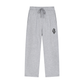 Light heather gray sweatpants with a drawstring waist and a small embroidered graphic on the left thigh, shown against a plain white background.